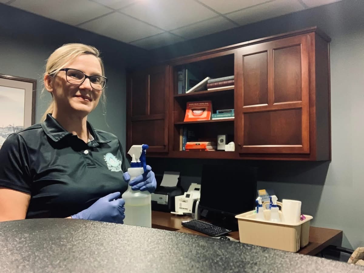 Patrisha Ryan at work with her cleaning supplies in a client’s office